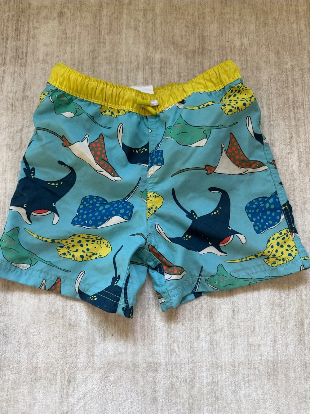Mini Boden Blue Swim Shorts with Yellow Waistband and Multicolor Ray Print